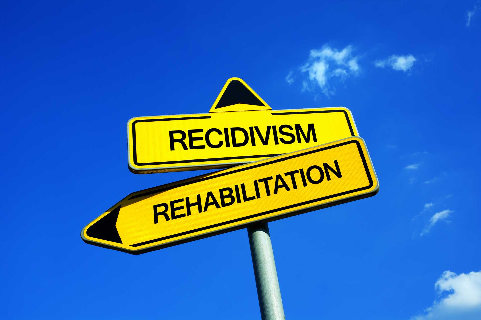 Recidivism or Rehabilitation - Traffic sign with two options - repeated criminality and sentencing of convicted criminal vs correction and reformation of former delinquent
